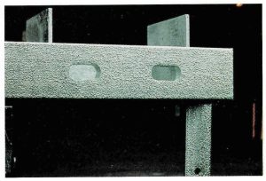 Description: Uniformly rough galvanized surface over entire section with uniform textured appearance.Cause: Rough surface condition of hot rolled structural section combined with high silicon content. Remedy: Change steel grade if surface finish is an issue. Positive effect on durability because of thicker galvanized coating produced.